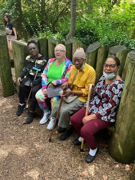 Friends resting together during a Sunshine Days park visit