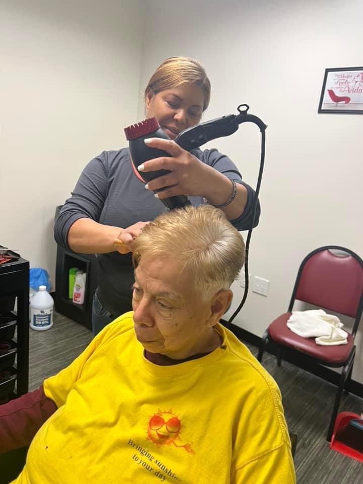 A Sunshine Days member receiving a haircut during Salon Day